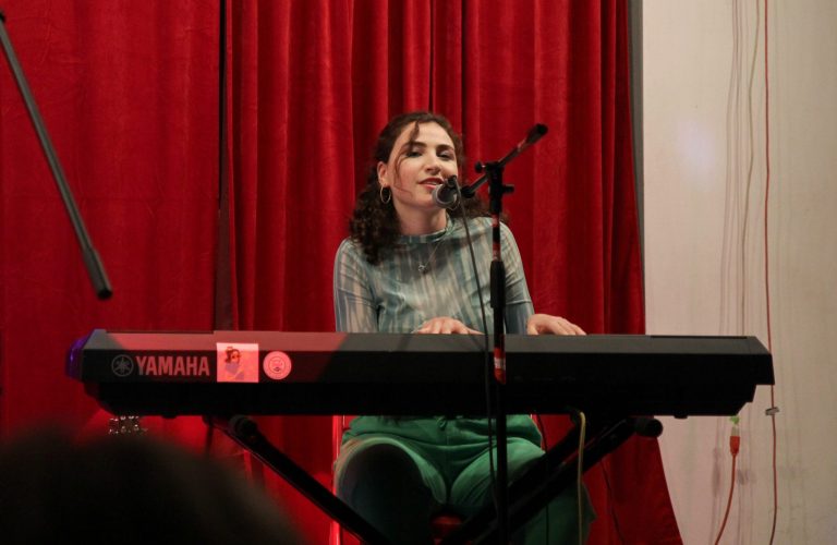 Haley Fishberger sings her original songs while playing a piano. Photo by Kate Kotlyar.